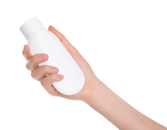 Young woman holding bottle with hand cream on white background