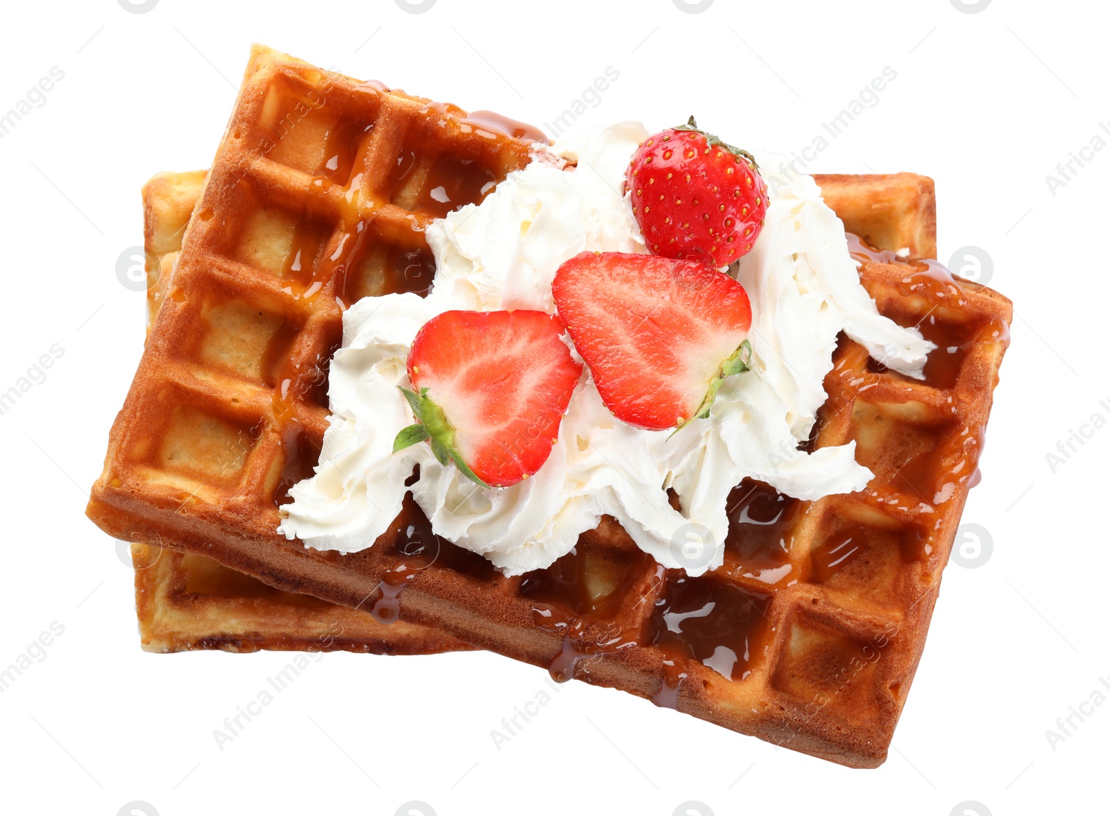 Photo of Delicious Belgian waffles with strawberries, whipped cream and caramel sauce on white background, top view