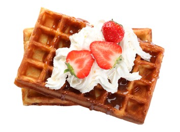 Delicious Belgian waffles with strawberries, whipped cream and caramel sauce on white background, top view