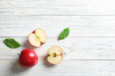 Fresh ripe red apples on wooden background