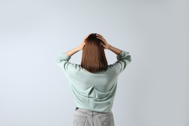 Girl wearing blouse on white background, back view