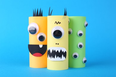 Spooky paper monsters on light blue background. Halloween decoration