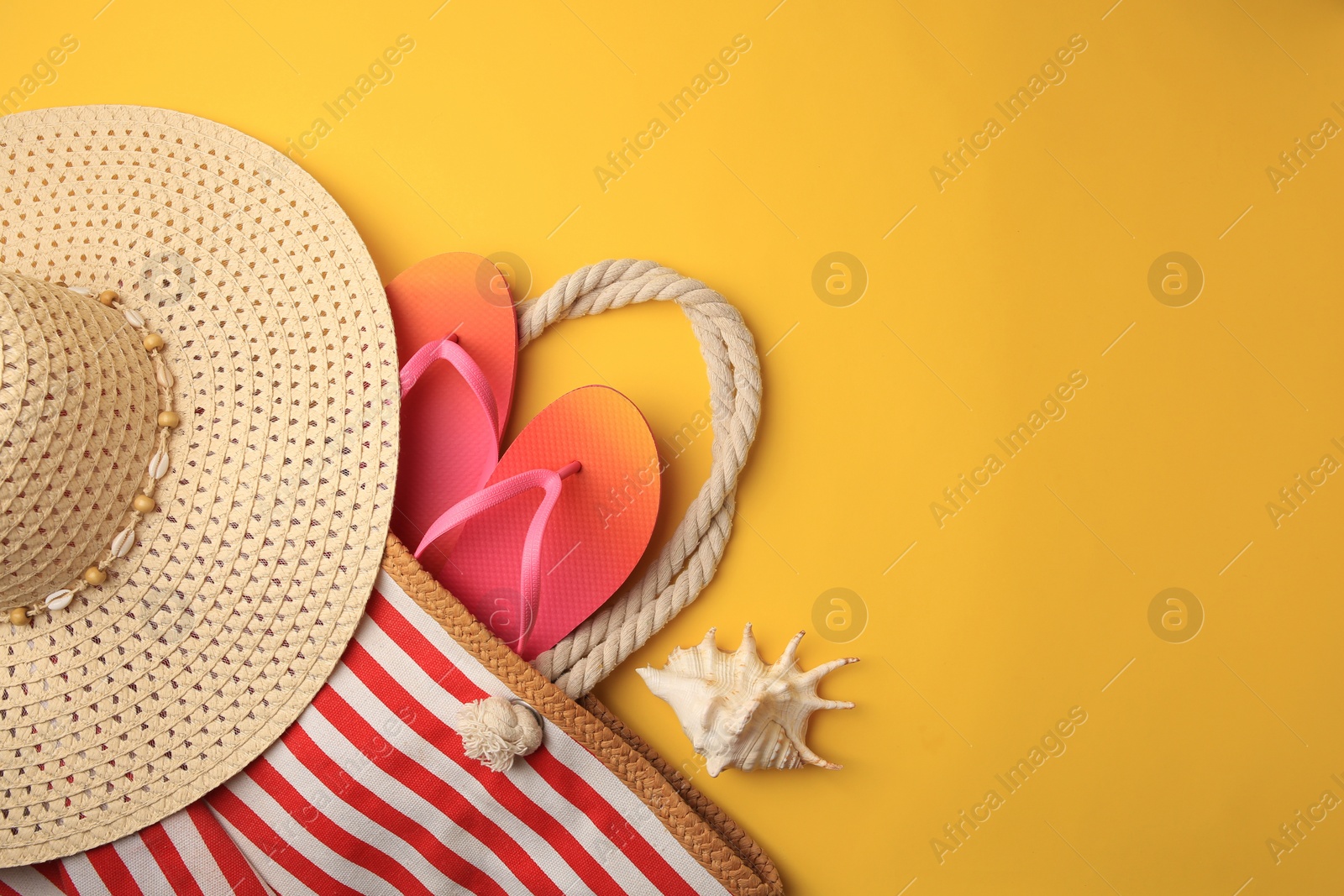 Photo of Flat lay composition with beach accessories on orange background, space for text