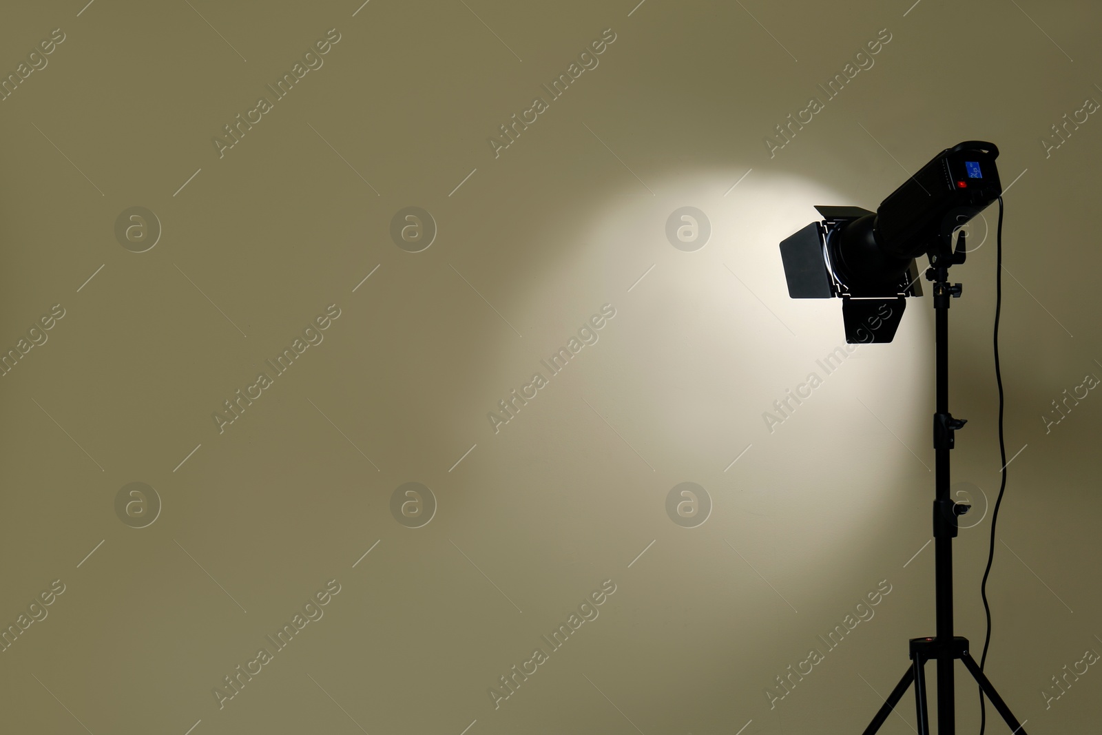 Photo of Modern spotlight against beige background, space for text