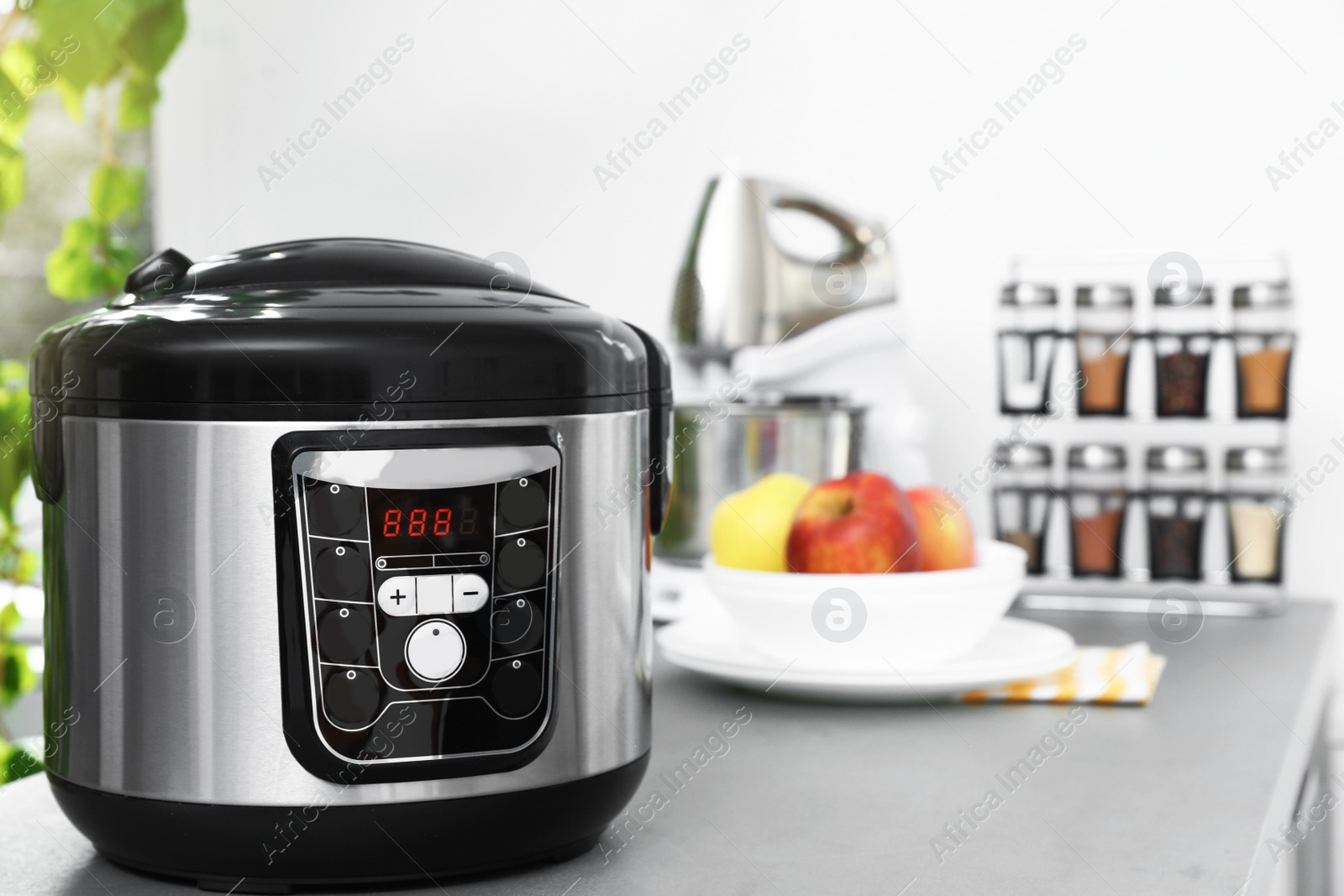 Photo of New modern multi cooker on table in kitchen. Space for text