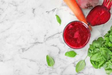 Photo of Glass of fresh beet juice and vegetables on table, top view