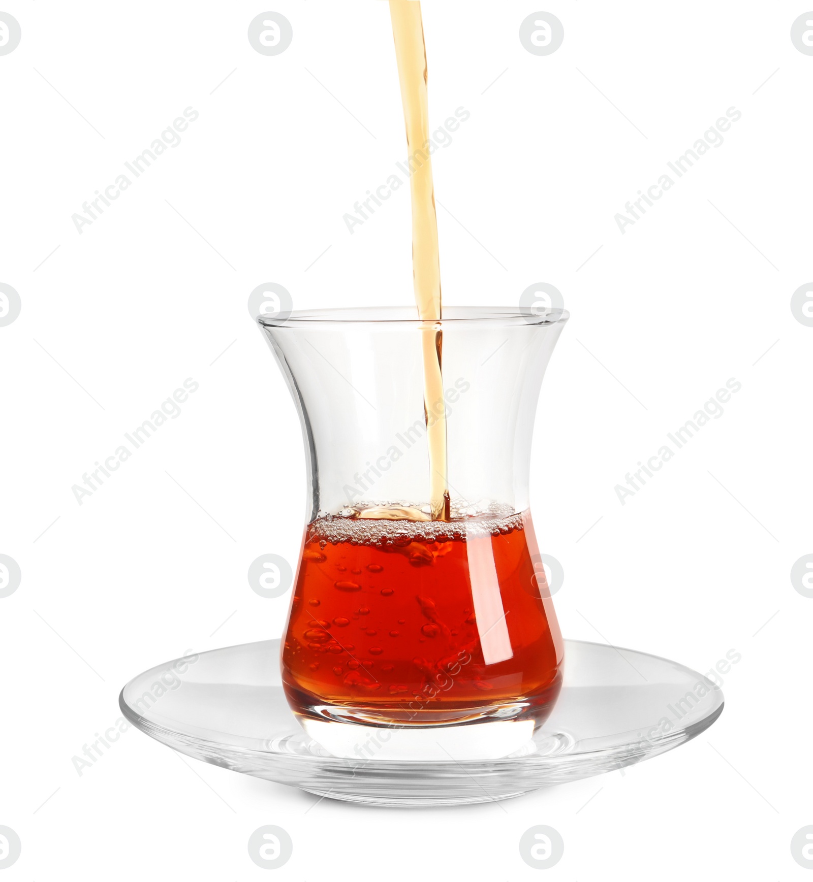 Photo of Pouring traditional Turkish tea into glass on white background