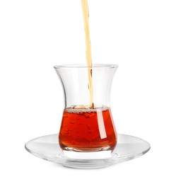 Photo of Pouring traditional Turkish tea into glass on white background