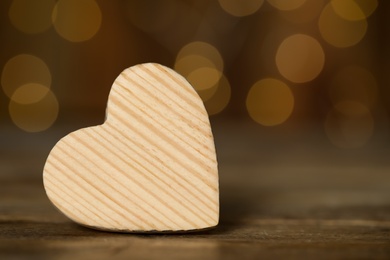 Photo of Wooden decorative heart on table against blurred background, space for text. Valentine's Day