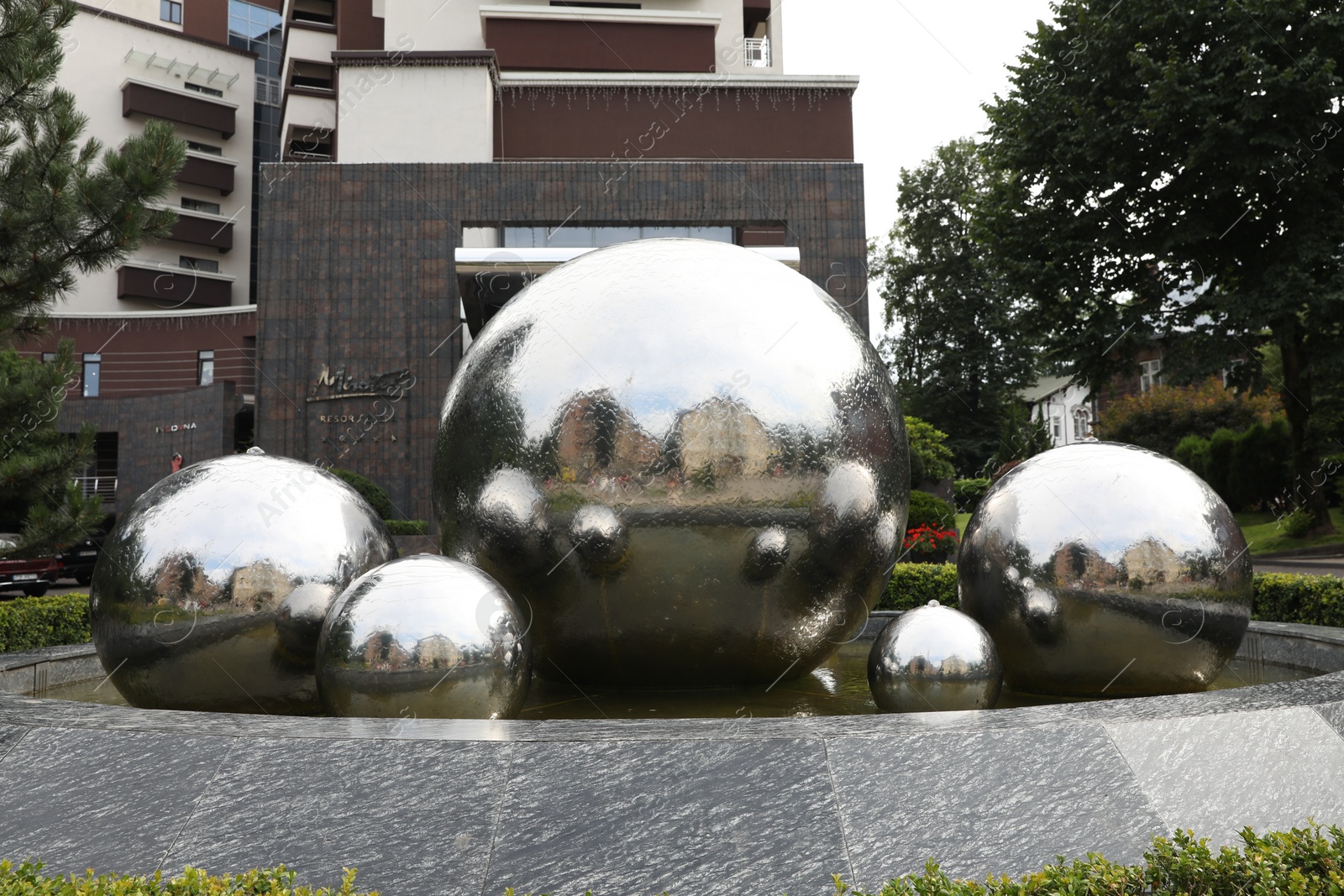 Photo of Truskavets, Ukraine - July 22, 2023: Beautiful fountain near hotel on city street