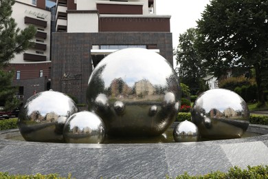 Photo of Truskavets, Ukraine - July 22, 2023: Beautiful fountain near hotel on city street