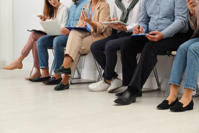 People waiting for job interview in office, closeup