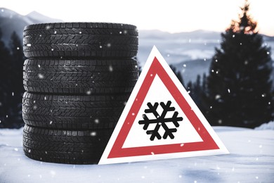 Image of Set of winter tires and road sign outdoors