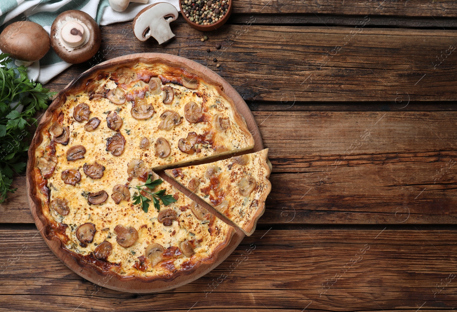 Photo of Delicious pie with mushrooms and cheese on brown wooden table, flat lay. Space for text