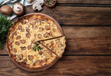 Photo of Delicious pie with mushrooms and cheese on brown wooden table, flat lay. Space for text