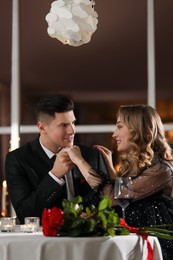 Photo of Lovely couple having romantic dinner on Valentine's day in restaurant