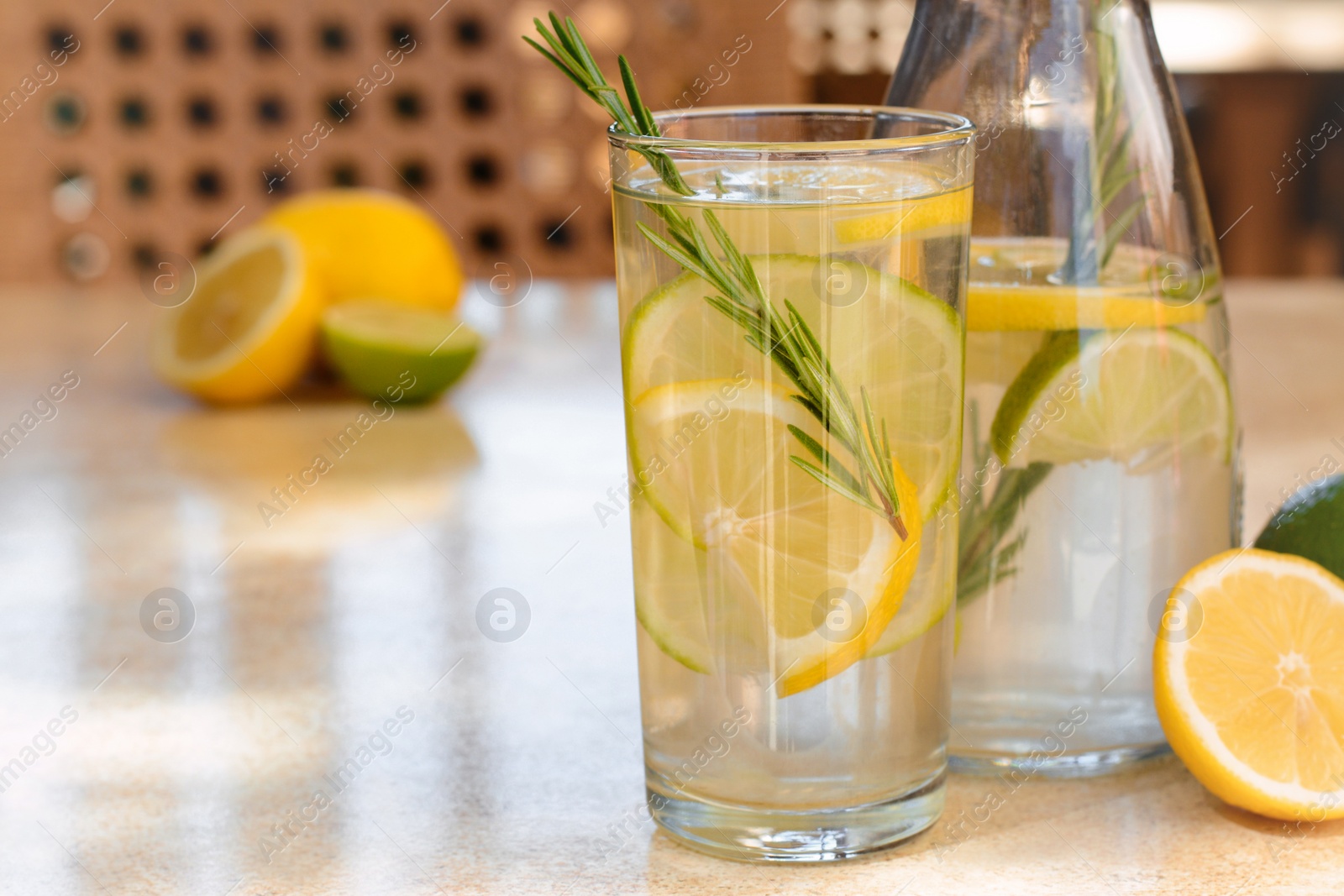 Photo of Summer refreshing lemonade on light table in cafe, space for text