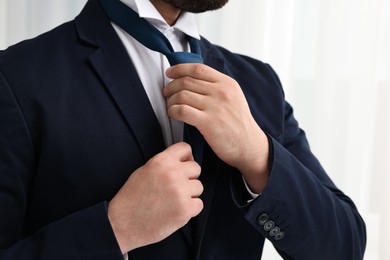 Photo of Businessman in suit and necktie indoors, closeup