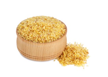 Wooden bowl with uncooked bulgur on white background