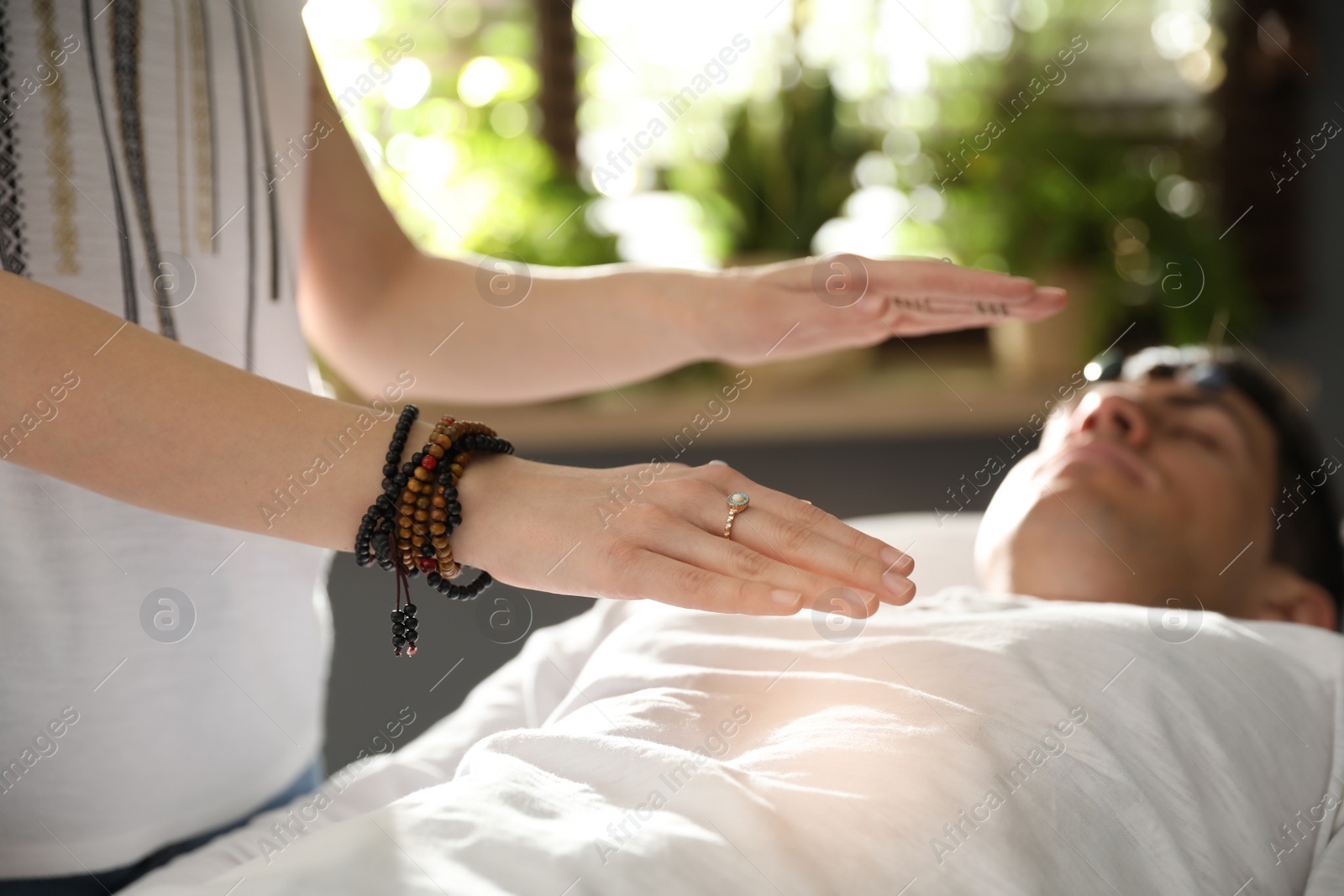 Photo of Man during crystal healing session in therapy room