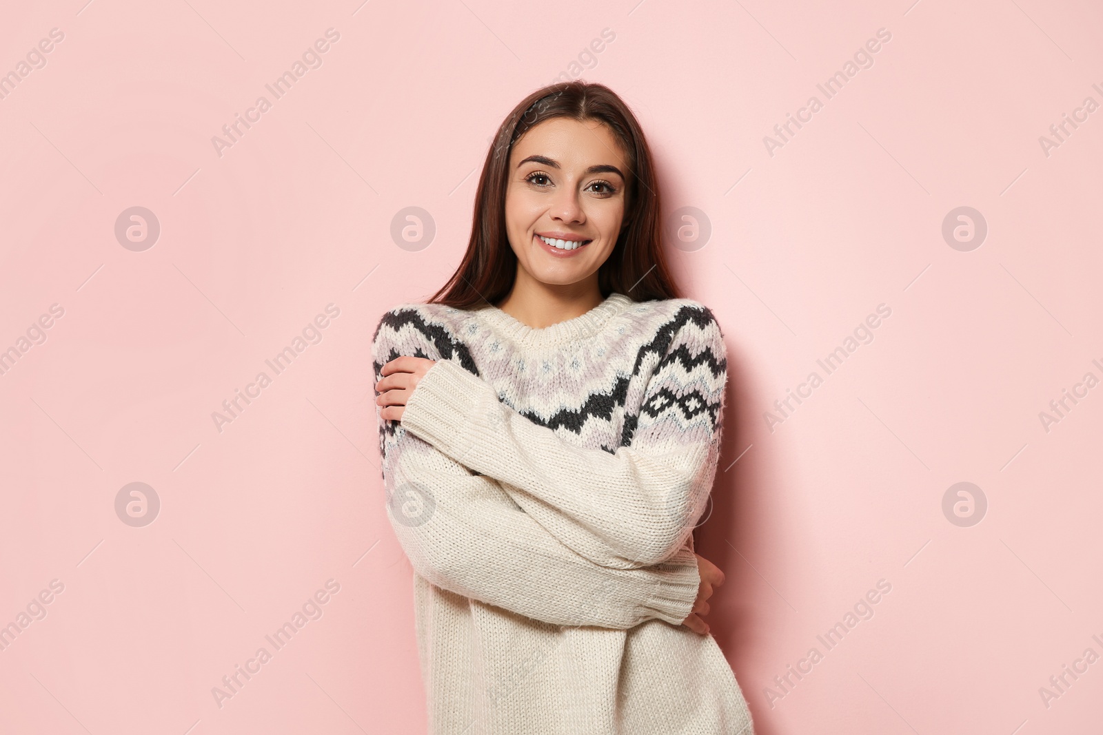 Photo of Beautiful young woman in warm sweater on color background