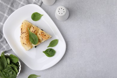 Photo of Piece of delicious puff pastry with spinach on light table, flat lay. Space for text