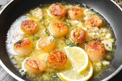 Photo of Delicious scallops with sauce in frying pan, closeup