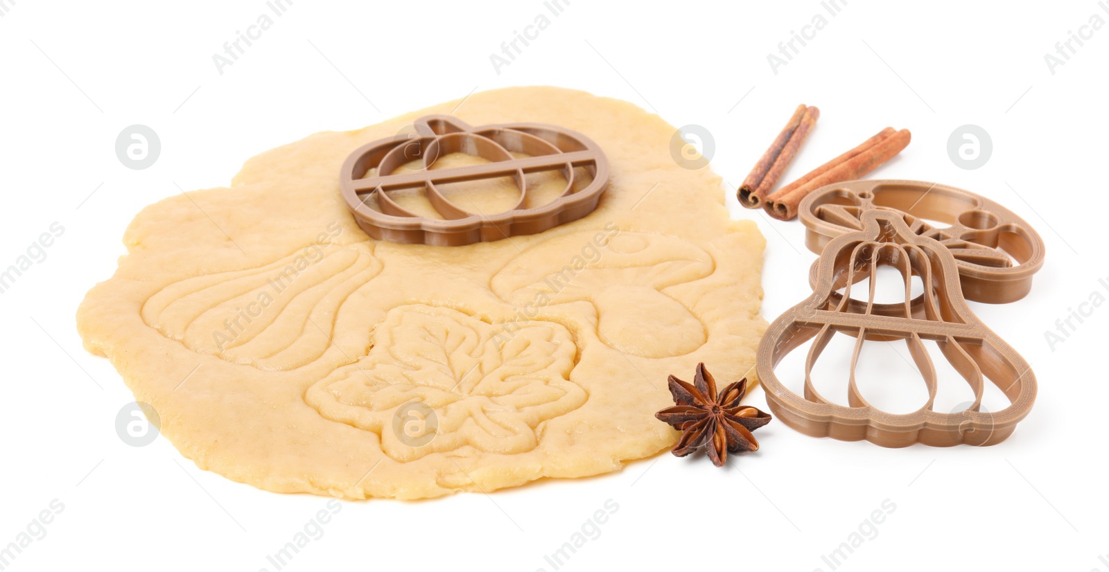 Photo of Cookie cutters, spices and dough on white background