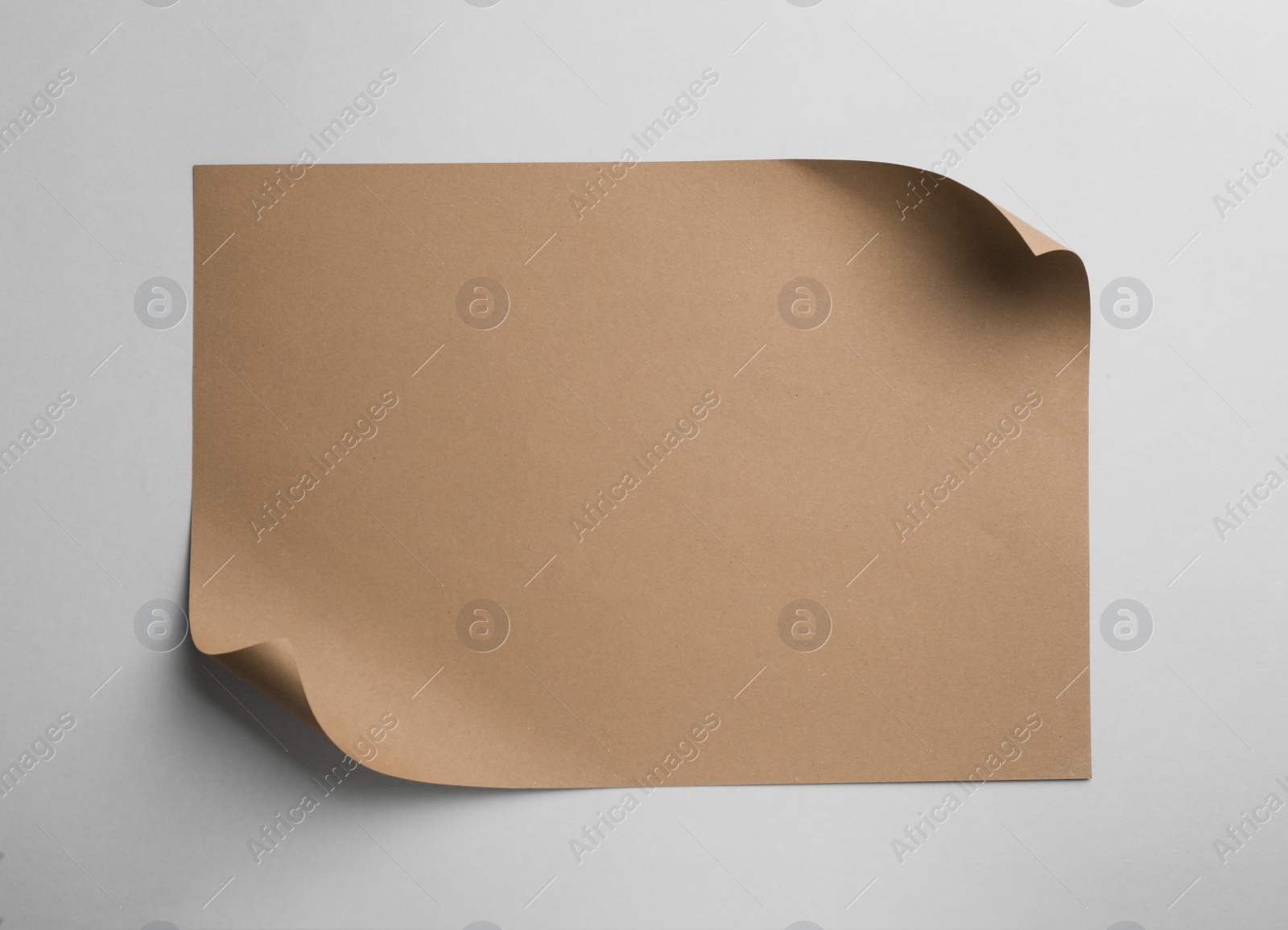 Photo of Sheet of brown paper on white background, top view