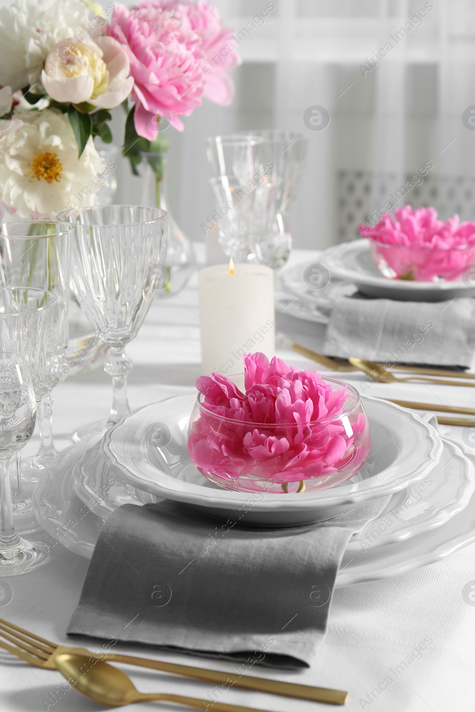 Photo of Stylish table setting with beautiful peonies in dining room