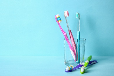 Photo of Cup with toothbrushes on color background. Dental care