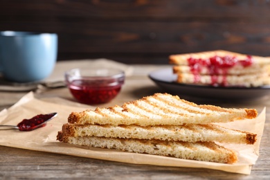 Tasty toasts served for breakfast on wooden table, closeup