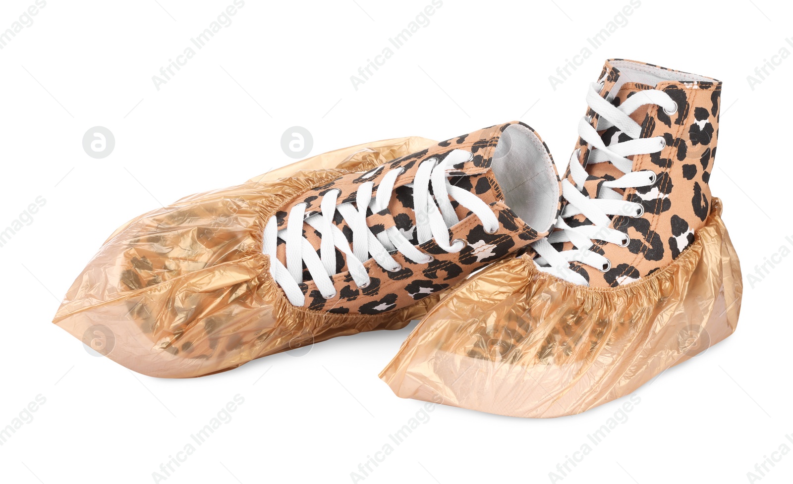 Photo of Sneakers in shoe covers isolated on white