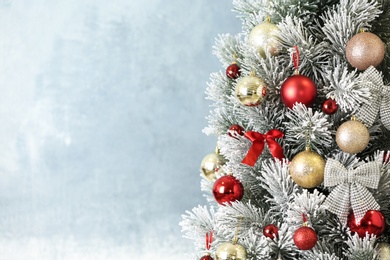 Photo of Beautiful Christmas tree with decor against light grey background. Space for text