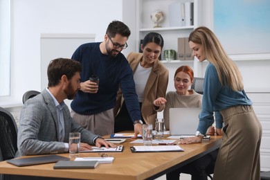 Team of employees working together in office