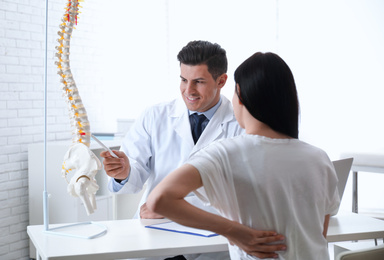 Photo of Young woman visiting orthopedist in medical office