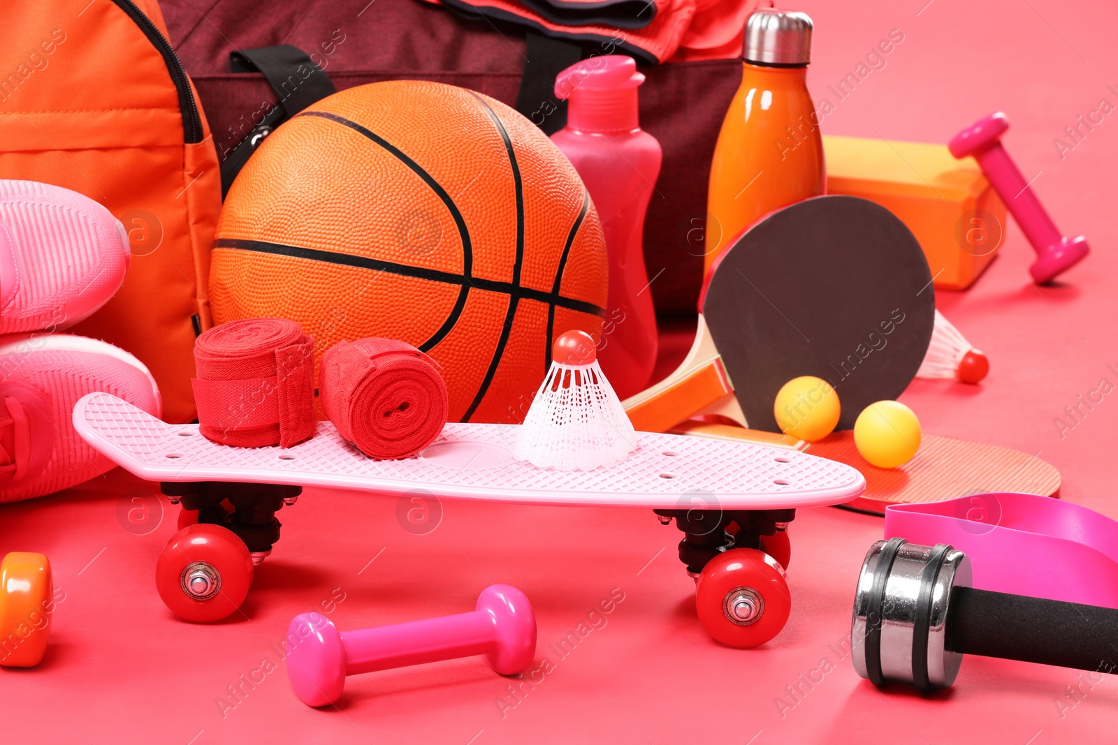 Photo of Many different sports equipment on red background