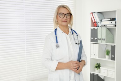 Photo of Doctor with stethoscope in clinic, space for text
