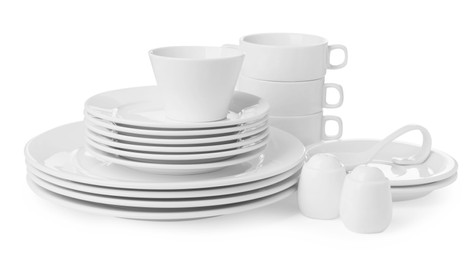 Photo of Set of clean dishware isolated on white