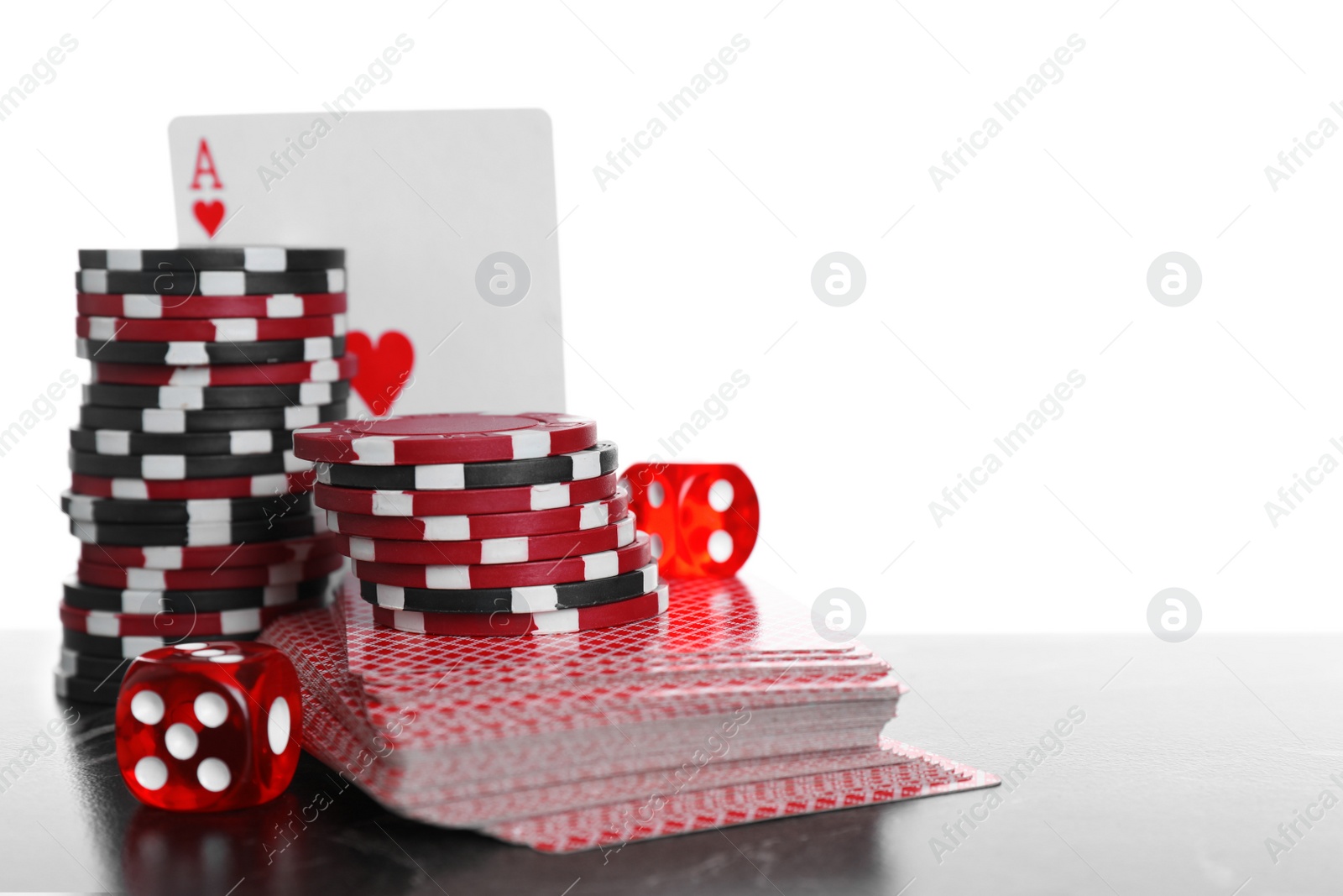 Photo of Gaming chips, dices and cards on table against white background