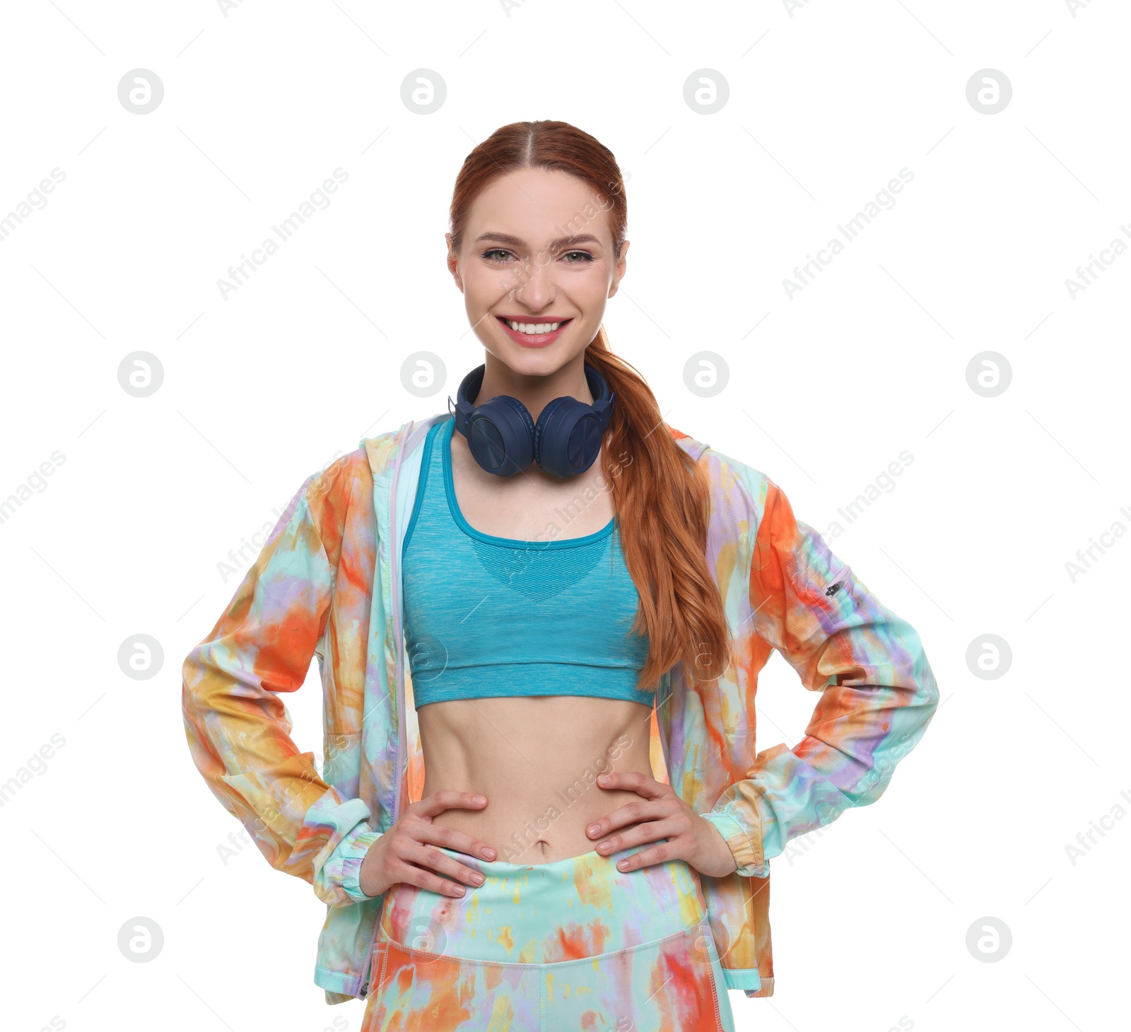 Photo of Young woman in sportswear and headphones on white background