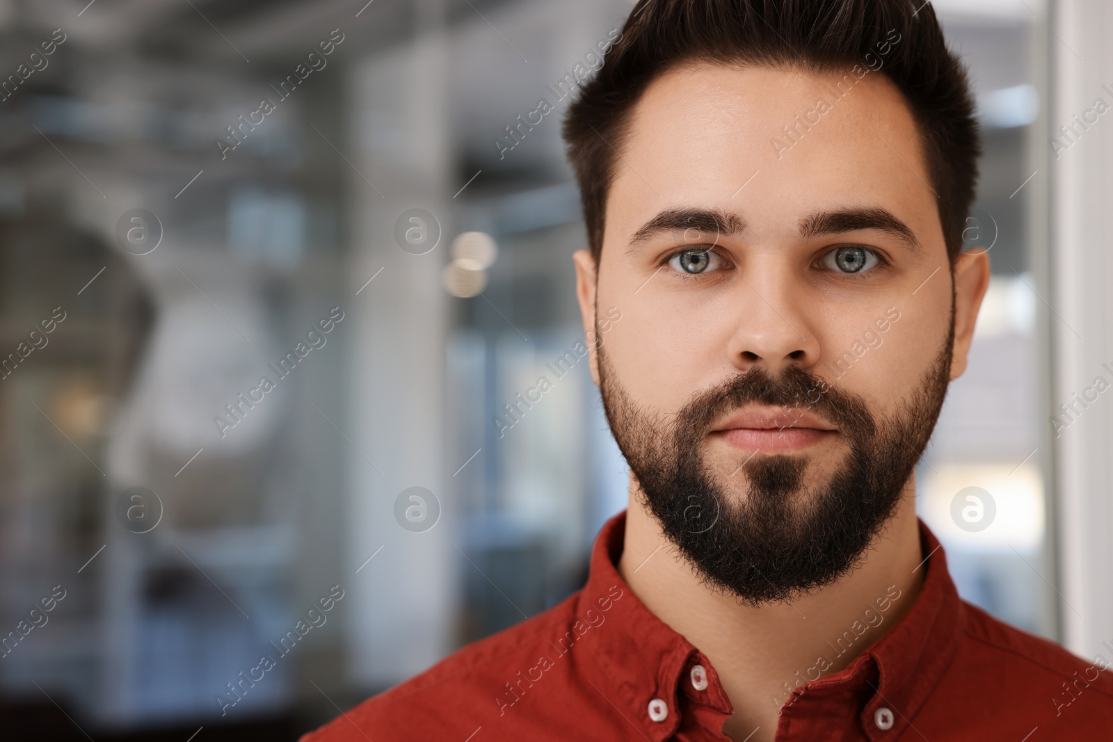 Photo of Portrait of attractive young man on blurred background, space for text