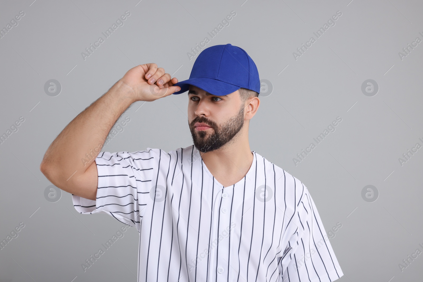 Photo of Man in stylish blue baseball cap on light grey background