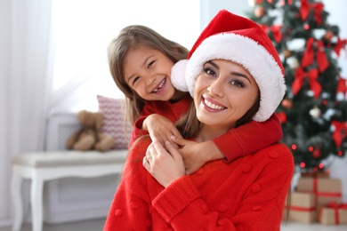 Happy mother and child celebrating Christmas at home