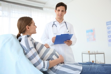 Photo of Gynecology consultation. Pregnant woman with her doctor in clinic