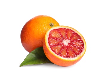 Photo of Whole and cut red oranges with green leaf isolated on white