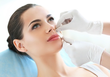 Photo of Woman getting wax epilation in salon