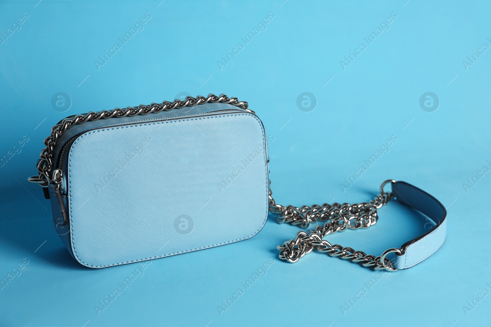 Photo of Stylish woman's bag on light blue background