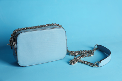 Stylish woman's bag on light blue background