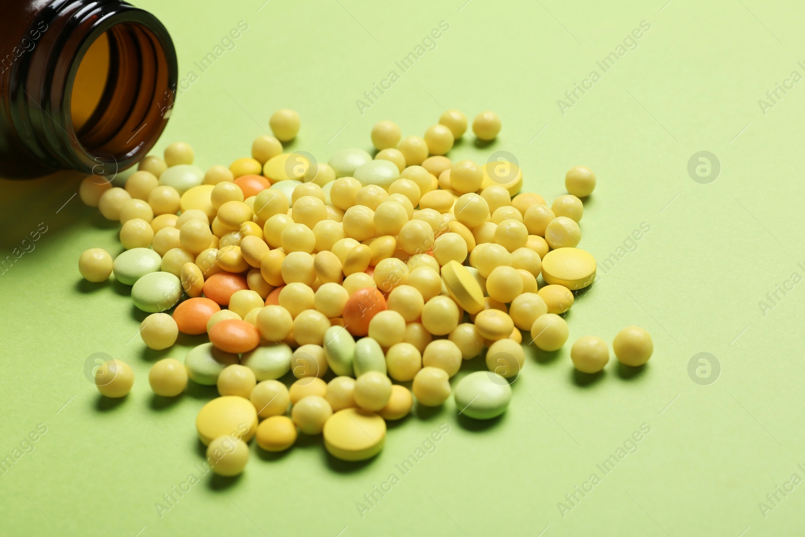 Photo of Bottle with vitamin pills on color background, closeup